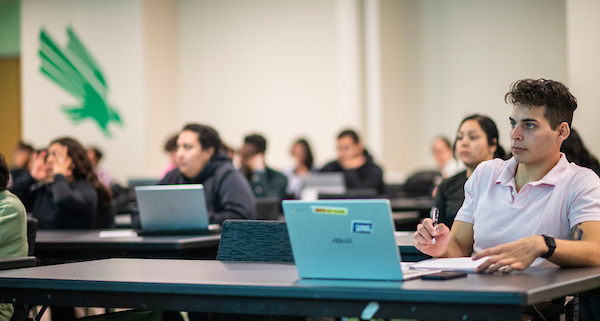 Students take notes on laptops in class