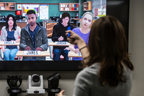 A student teacher lectures in a digital classroom enviornment