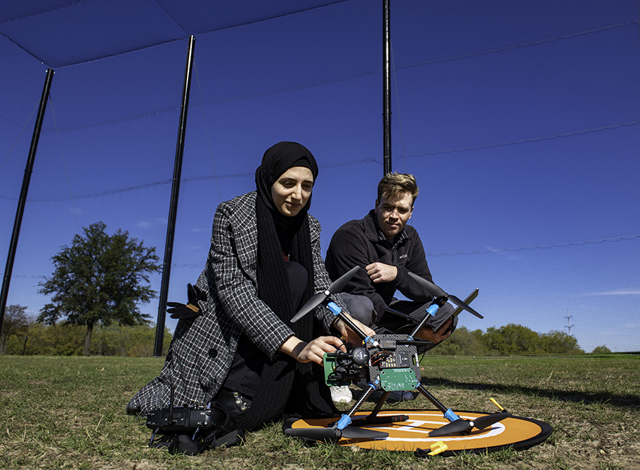 A student and instructor working with a drone at UNT's CIIMS
