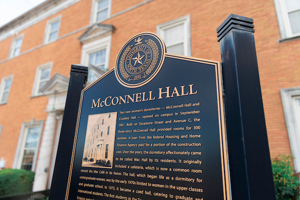 Exterior of McConnell Hall and its historical plaque