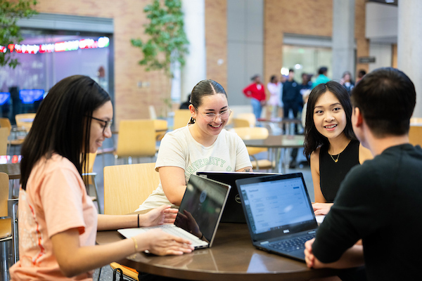 Students working together in the BLB atrium