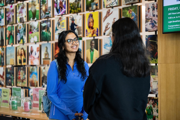A student chatting with faculty at UNT Frisco