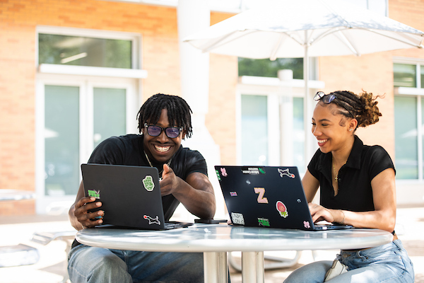 Students take notes on laptops