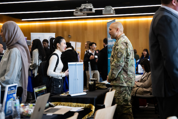 A student speaks with a recruiter at a career fair