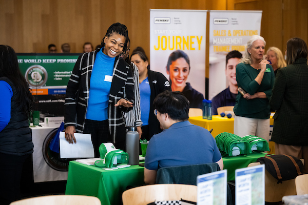 A woman speaks with a recruiter at a UNT career fair