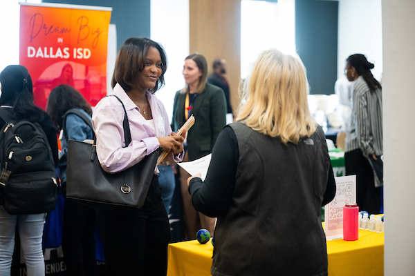 A student meets with a recruitment representative at the Frisco Career Fair event