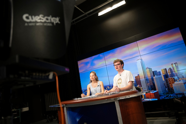 UNT media arts students at an on-campus news desk
